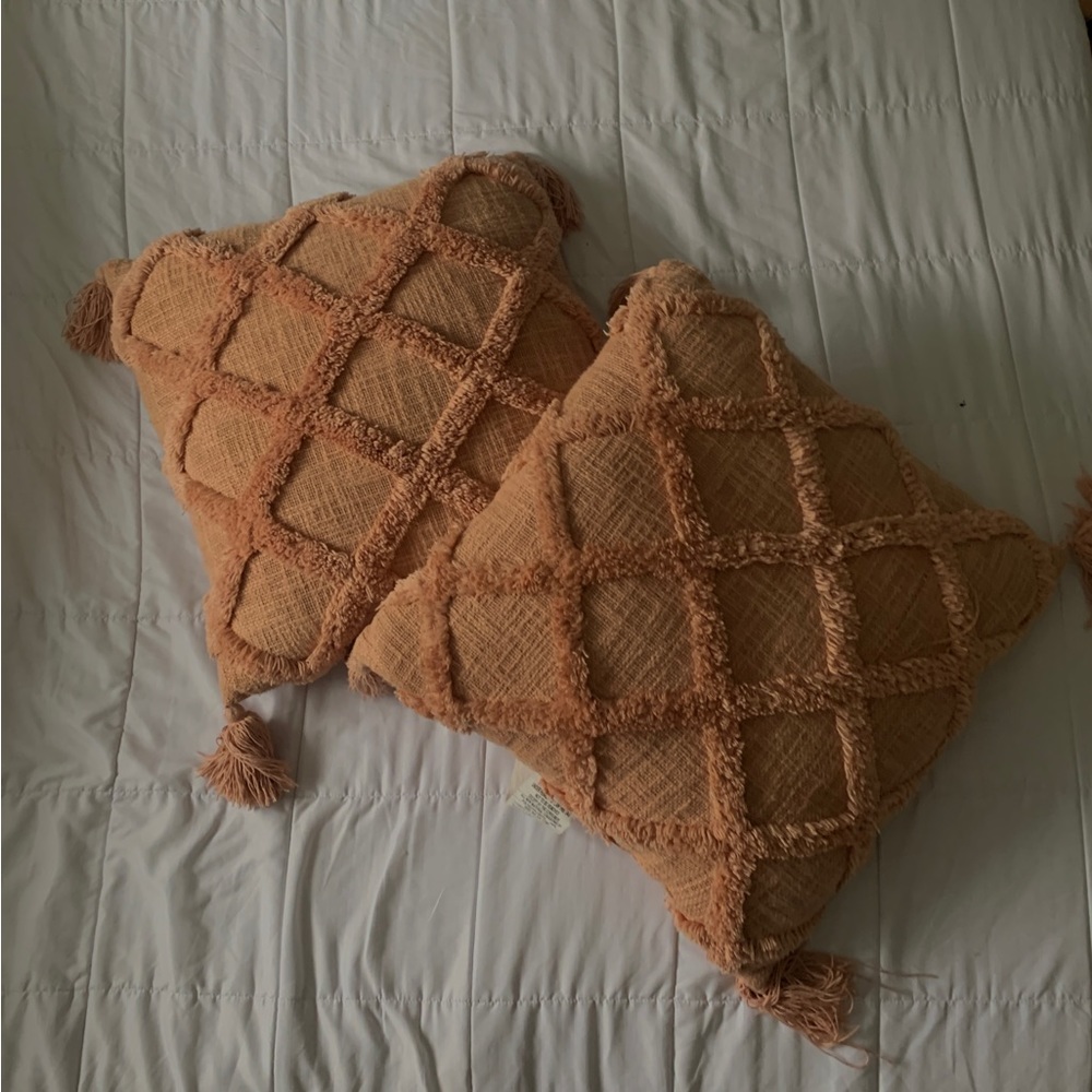Peach boho throw pillows with tassels